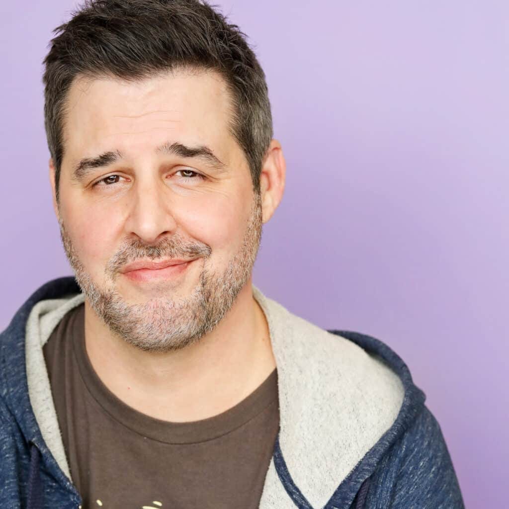 a man with a beard and mustache wearing a hoodie